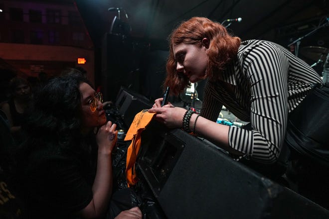 Libby DeCamp of The Moonrisers signs a bag for Chanel Falatea at Mohawk Austin during South by Southwest on Thursday, March, 14, 2024.