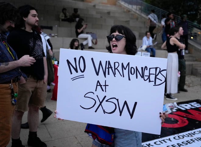 Wellington, New Zealand, artist Bella Guarrera, who performs with Vera Ellen, demonstrates at the Anti-SXSW Fest at City Hall Thursday March 14, 2024. The show featured several bands who boycotted SXSW in opposition to the U.S. Army being a sponsor.